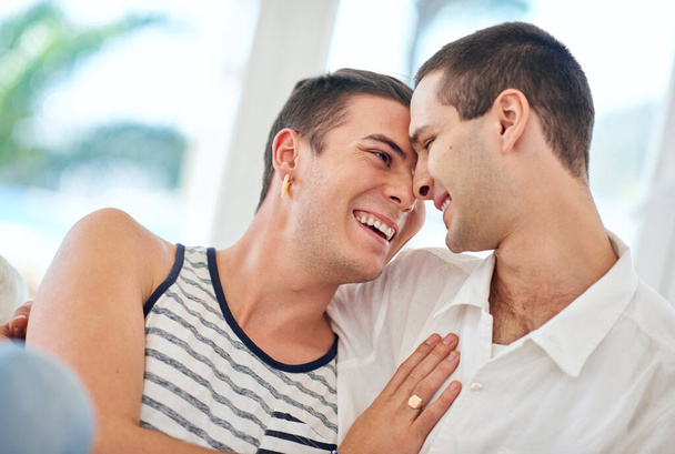 Laughter and love. a gay couple relaxing together at home - Foto, Imagem