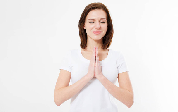 girl in t-shirt prays with closed eyes - Foto, Imagem