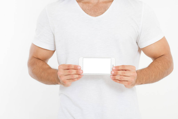Man holding white phone. Cellular isolated on white clipping path inside. Top view.Mock up.Copy space.Template.Blank. - Photo, Image