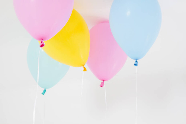 Colorful party balloons background. Isolated on white. Copy space - 写真・画像