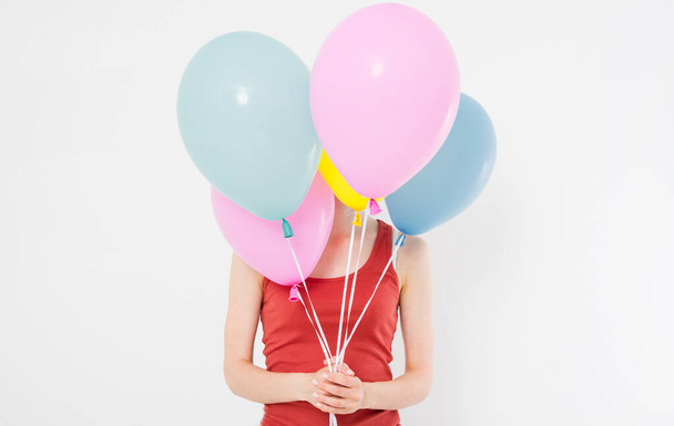 young woman girl with colored balloons isolated on white background. Copy space - Photo, image