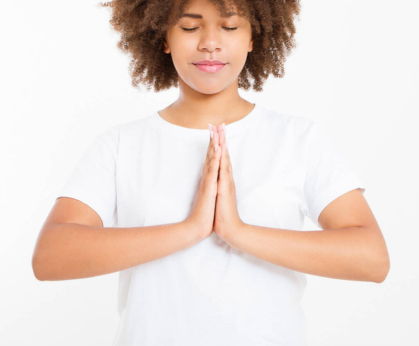 Close-up of hands of black, afro american woman in white clothes meditating indoors, focus on arms in Namaste gesture. Healthy lifestyle concept. Mock up. Copy space. Template. Blank. - Фото, зображення
