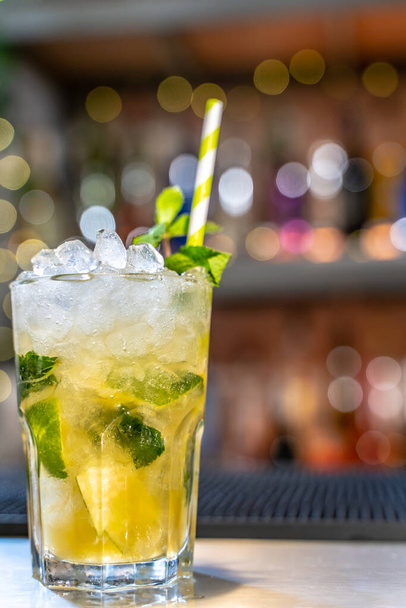 Mojito cocktail on bar counter with lemons, limes and species with copy space for text. High quality photo - 写真・画像