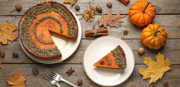 Composition with delicious pumpkin pie on wooden background, top view - Photo, Image
