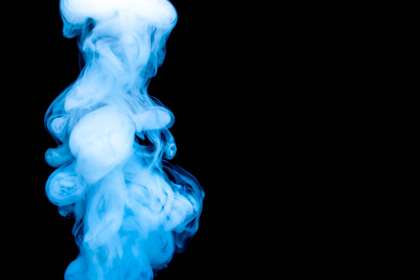 puffs of thick blue smoke against a black background - Φωτογραφία, εικόνα