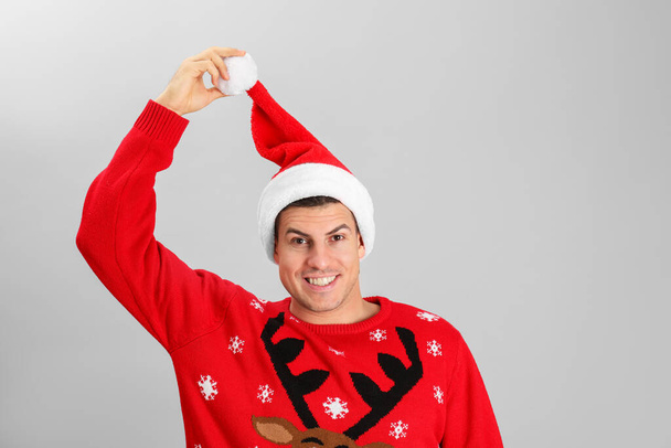 Handsome man wearing Santa hat on grey background - Фото, изображение