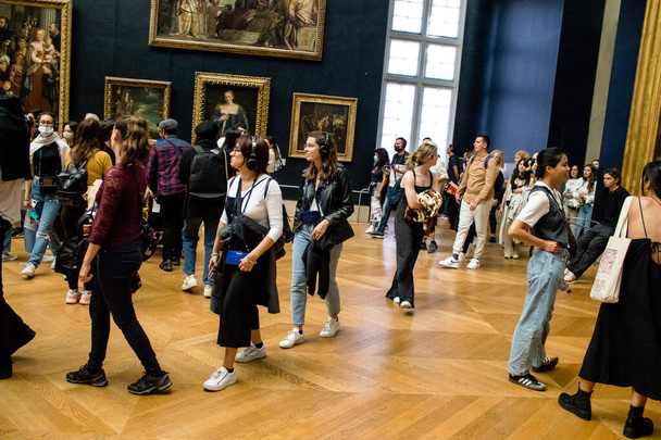 Paris, Fransa - 08 Eylül 2022 Dünyanın en büyük müzesi Louvre, sanat için ikonik bir yer, ziyaretçiler mermer heykellere ve usta resimlere hayran olmak için koridorlarda dolaşıyorlar. - Fotoğraf, Görsel