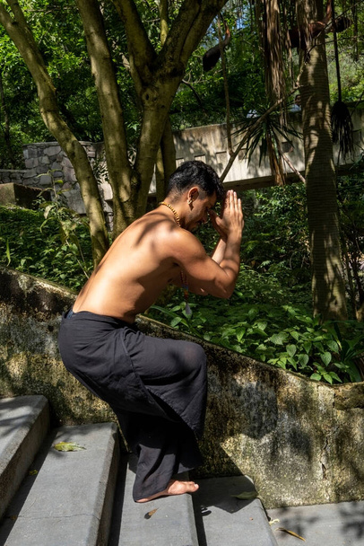 young man, doing yoga or reiki, in the forest very green vegetation, in mexico, guadalajara, bosque colomos, hispanic, latin america - Photo, Image