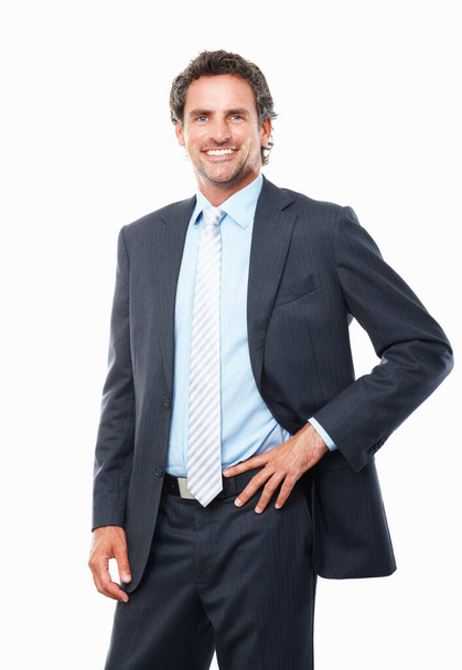 Selbstbewusster Geschäftsmann lächelt. Porträt eines gut aussehenden Geschäftsmannes, der mit der Hand auf der Taille steht und lächelt - Foto, Bild