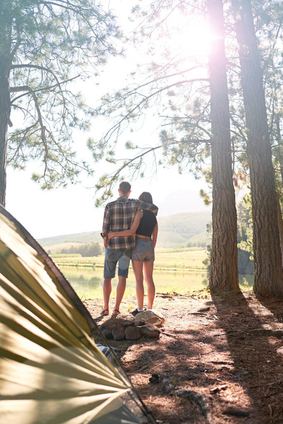 Elegimos un puesto impresionante para acampar. una joven pareja acampando junto a un lago - Foto, imagen