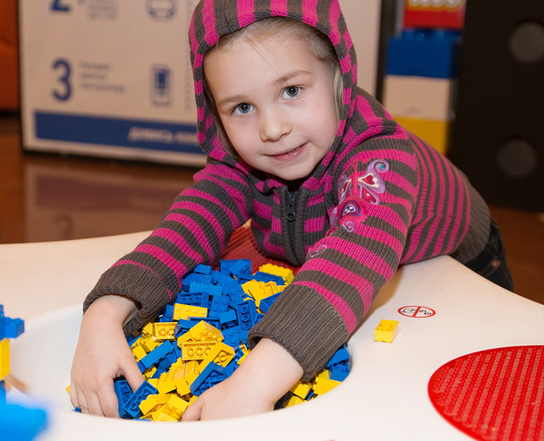 Маленька дівчинка грає в будівельні блоки
 - Фото, зображення