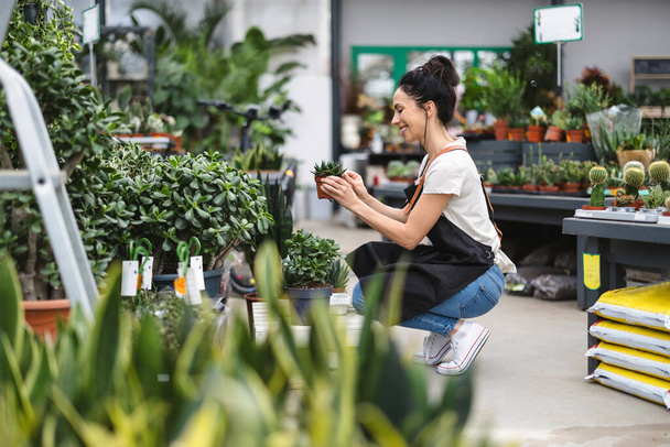 Woman working in a garden center - Photo, Image