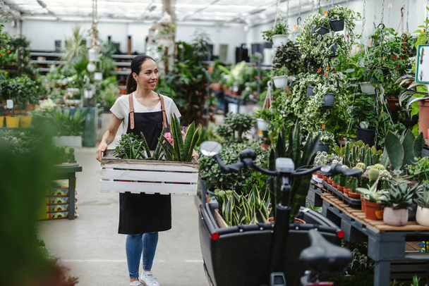Woman working in a garden center - Photo, Image