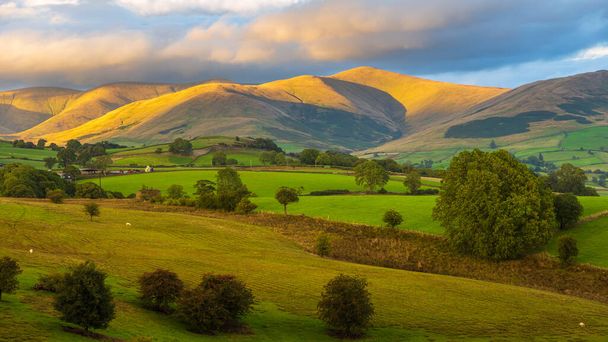 View of the small village Sedbergh. Sunset over green hills in Yorkshire Dales, Cumbria. Rural landscape, north UK. - Photo, Image