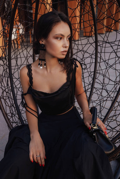 fashion outdoor photo of beautiful woman with dark hair in elegant dress with accessories - Zdjęcie, obraz