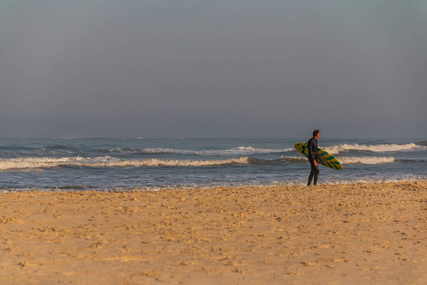 Sörf tahtasıyla sörf yapan yaşlı bir sörfçü - Fotoğraf, Görsel