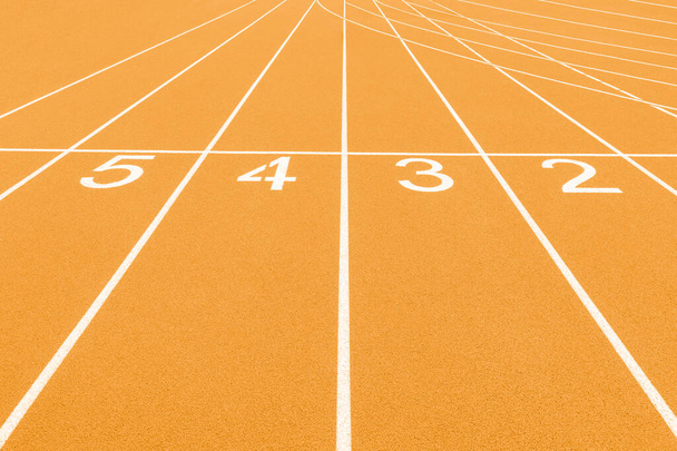 Yellow track and field lanes and numbers. Running lanes at a track and field athletic center. Horizontal sport theme poster, greeting cards, headers, website and app - Φωτογραφία, εικόνα