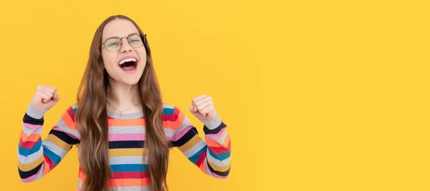 happy schoolgirl nerd teen girl in eyeglasses for vision celebrating success, success. Child face, horizontal poster, teenager girl isolated portrait, banner with copy space - Photo, Image