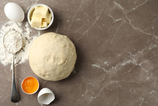 Flat lay composition with dough on marble table, space for text. Cooking pastries - 写真・画像