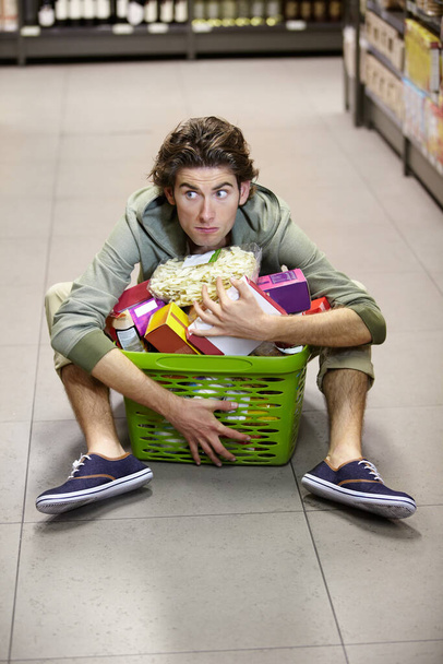 Nope, I need all of this. A young man determined to keep his groceries - Fotoğraf, Görsel