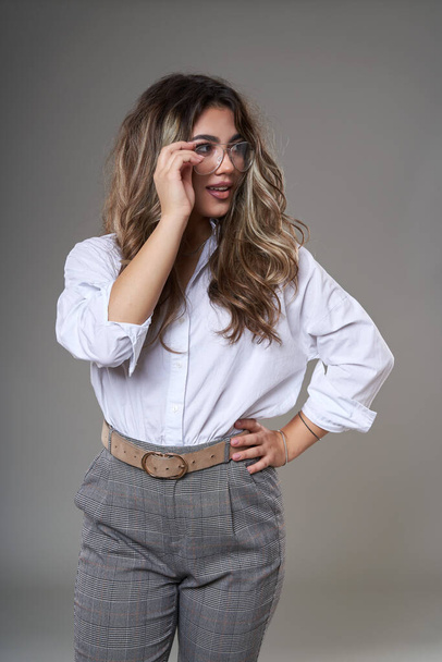 Very attractive young businesswoman in glasses, closeup studio portrait on gray background - Fotografie, Obrázek