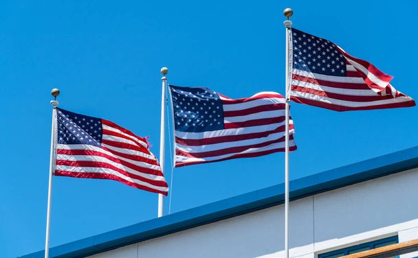 usa flags on blue sky background - Photo, image