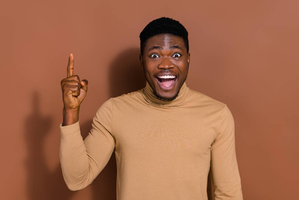 Photo of hooray millennial brunet guy index up wear beige shirt isolated on brown color background. - Φωτογραφία, εικόνα