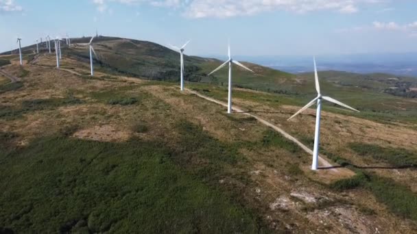 eolic generators spining with the wind in the mountains on a sunny day. High quality 4k footage - Materiał filmowy, wideo