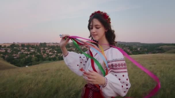 happy young woman enjoying the sunset, wearing traditional ukrainian clothes. lifestyle in Ukraine - Video