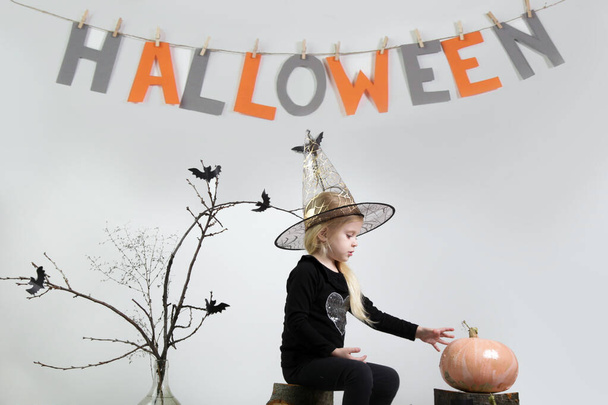 Halloween studio portrait of cute 4 years old girl. - Fotó, kép