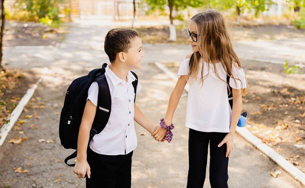 Two funny happy students kids on 1 September day. Education and back to school concept. Children pupils ready to learn and study. High quality photo - Foto, Imagen