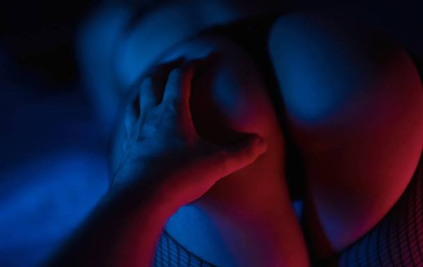 Man's hand is touching sexy woman butt. - Zdjęcie, obraz
