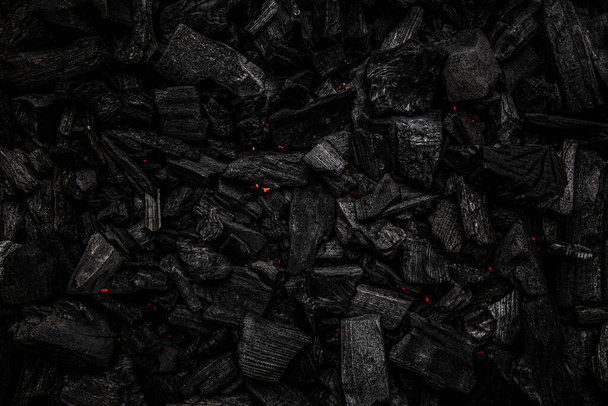Charcoal with red streaks of heat. Textured dark background. - Foto, Imagem