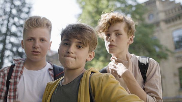 Aggressive school boys intimidating classmate pov, physical bullying problem - Valokuva, kuva