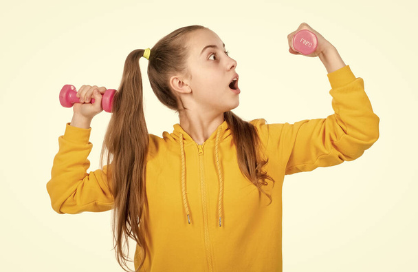 child training with barbells. childhood health. healthy life. kid with sport equipment isolated on white. determination. surprised strong teen girl with dumbbell. sport and fitness. - Foto, Bild