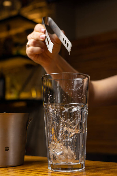A bartender prepares a cocktail at the restaurant bar - Photo, Image
