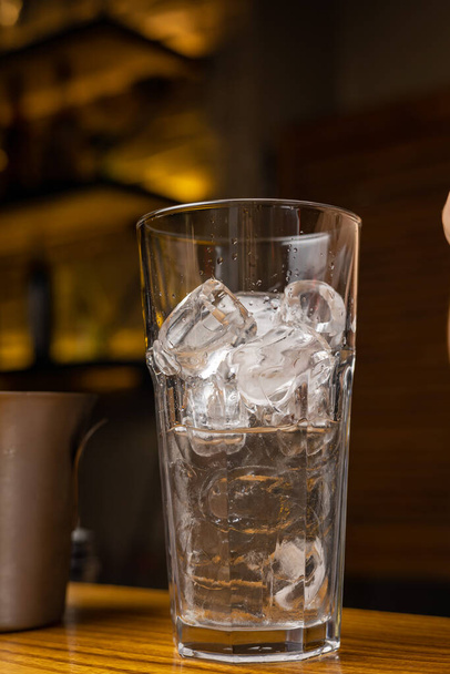 A bartender prepares a cocktail at the restaurant bar - Фото, зображення