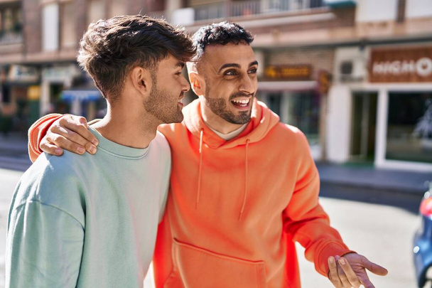 Twee man paar knuffelen elkaar staan op straat - Foto, afbeelding