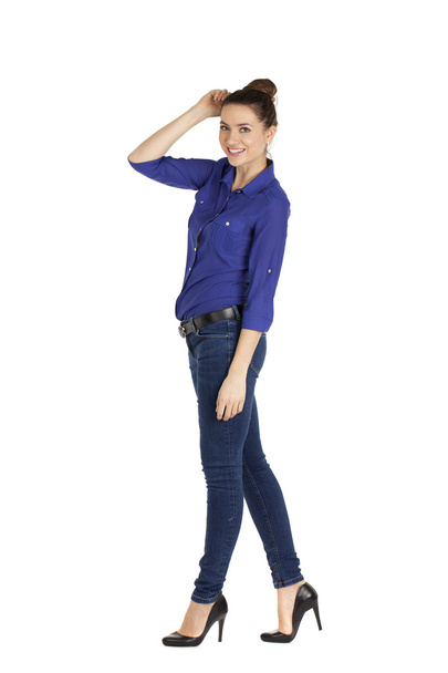 Portrait of a beautiful woman in blue jeans and blue shirt - Фото, изображение