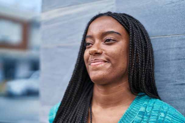 Afričanky americká žena se usmívá sebevědomě dívá na stranu na ulici - Fotografie, Obrázek