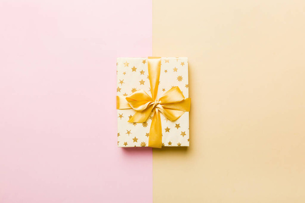 holiday paper present tied yellow ribbon bow top view with copy space. Flat lay holiday background. Birthday or christmas present. Christmas gift box concept with copy space. - Fotó, kép