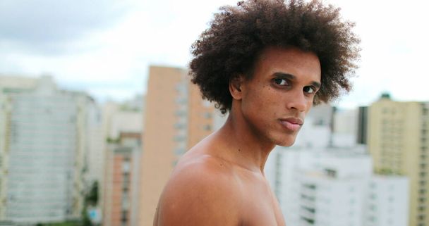Young handsome african american man posing to camera with stoic expression - 写真・画像