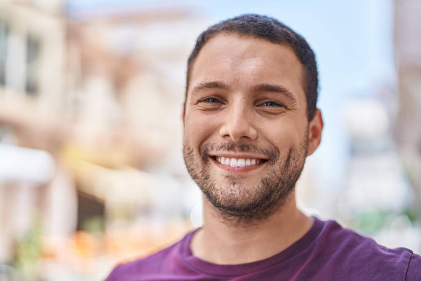 Young man smiling confident standing at street - Fotó, kép