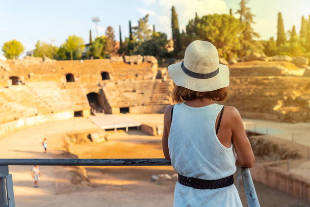 Merida Roman Ruins, a young woman visiting the Roman Amphitheater at sunset. Extremadura, Spain - 写真・画像