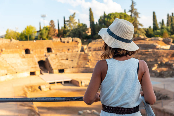 Roman Ruins of Merida, a young woman visiting the Roman Amphitheater. Extremadura, Spain - Fotografie, Obrázek