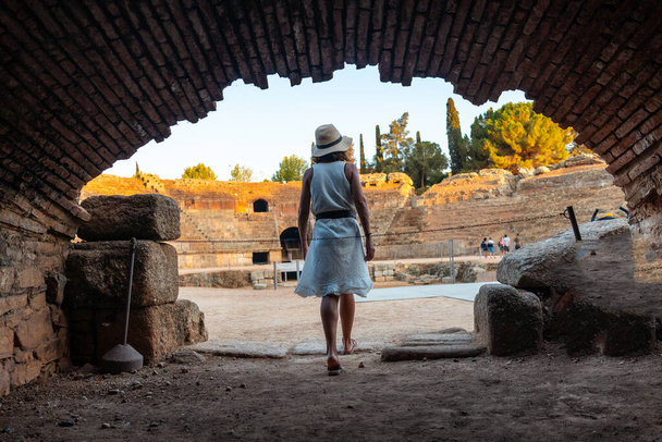 Roman Ruins of Merida, a young tourist in the Roman Amphitheater from the inside. Extremadura, Spain - Φωτογραφία, εικόνα