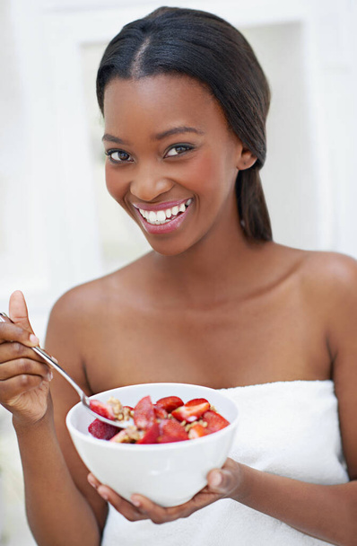 My day cant get any sweeter. a beautiful young woman eating strawberries - Photo, Image