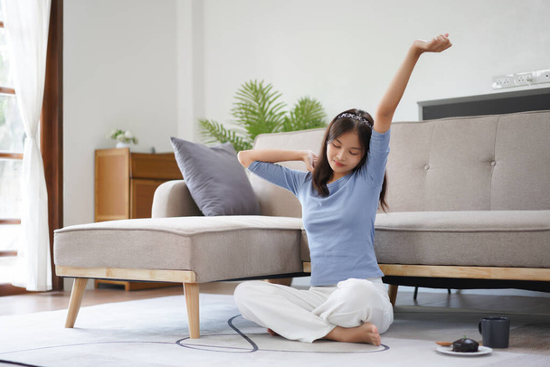 Work from home concept, Business women sit on floor and stretching to relax after working at home. - Fotoğraf, Görsel