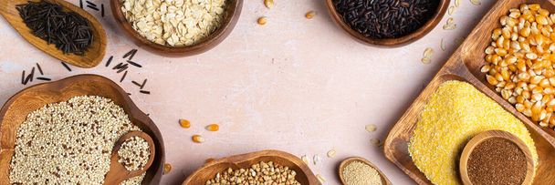 Healthy eating, dieting, balanced food concept. Assortment of gluten free cereals, corn, rice, amaranth, teff, buckwheat, quinoa and oat on a table. Top view flat lay background, banner - Photo, image