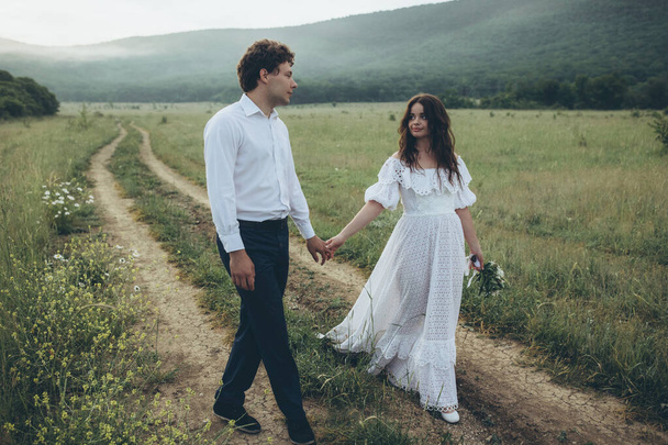 Beautiful wedding couple in nature. Wedding. Bride and groom on their wedding day. High quality photo - Foto, afbeelding